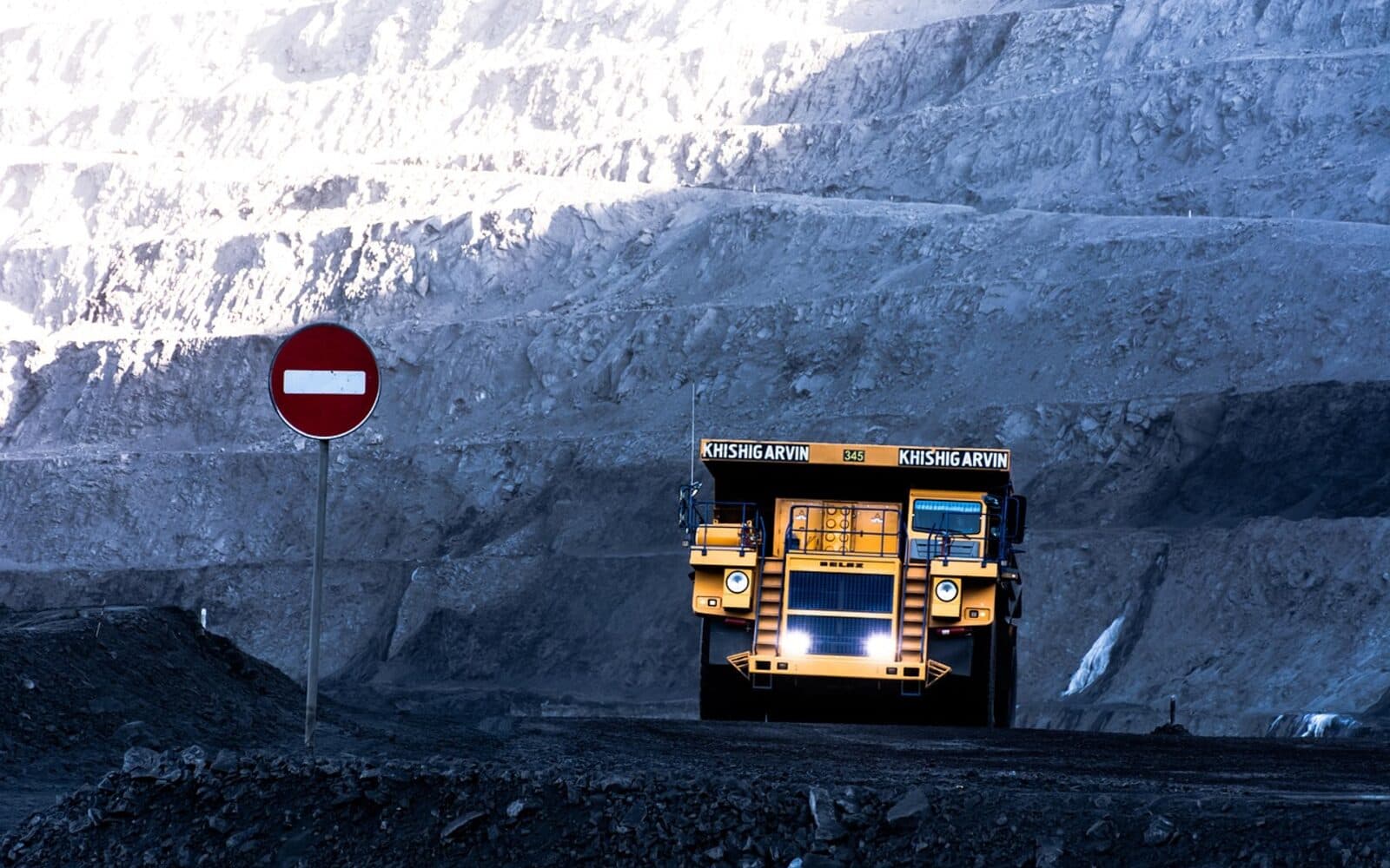 Concept image of large MSC Mining haul truck operating inside a terraced open-pit mine, with a no-entry safety sign in the foreground.