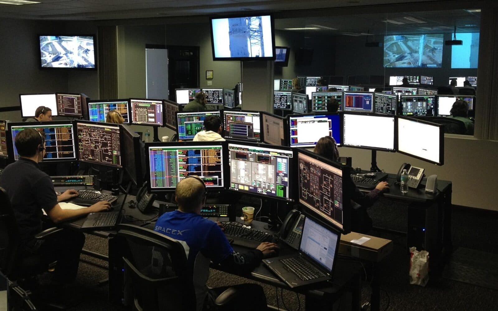 Concept image of an MSC Mining operations control room with engineers monitoring multi-screen dashboards and live site video feeds.