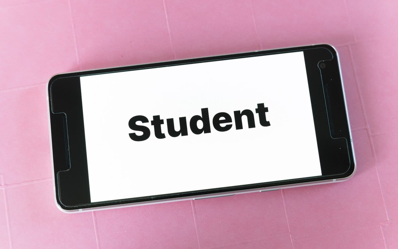 Concept image of the Student Life digital student card displayed on a smartphone screen with the word 'Student' in bold type.